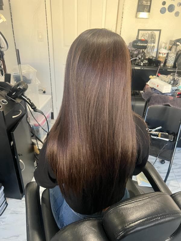 Long, layered hair with a smooth and shiny finish